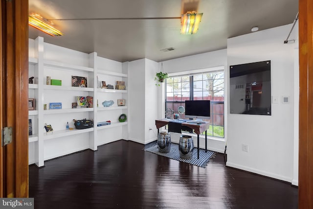 office area featuring visible vents, dark wood-style flooring, and baseboards