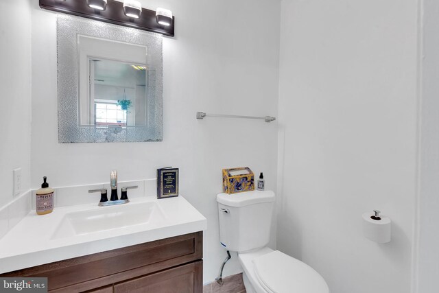 bathroom featuring toilet and vanity