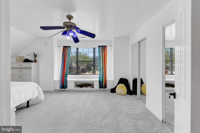 carpeted bedroom with baseboards, a ceiling fan, and lofted ceiling