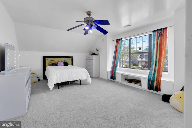 bedroom with carpet, a ceiling fan, visible vents, and lofted ceiling