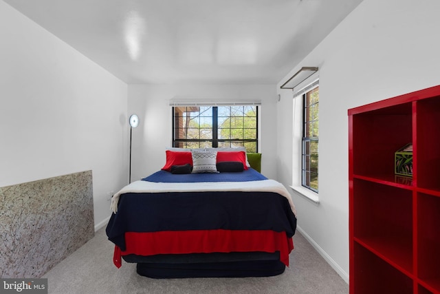 carpeted bedroom featuring baseboards