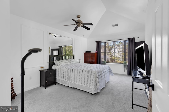 bedroom featuring visible vents, ceiling fan, vaulted ceiling, and light carpet