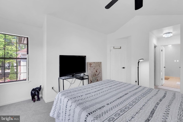 bedroom featuring carpet flooring, multiple windows, vaulted ceiling, and baseboards