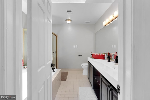 bathroom with visible vents, toilet, a shower with door, and vanity