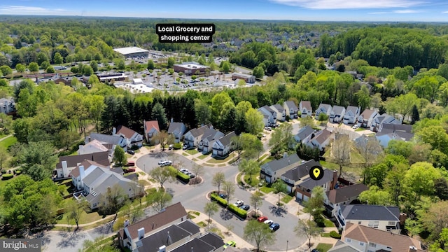 drone / aerial view featuring a residential view and a forest view