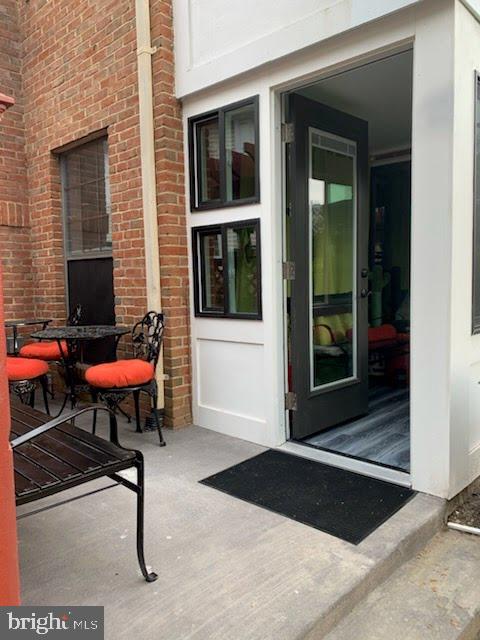 entrance to property featuring brick siding