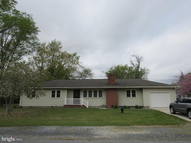 ranch-style house featuring driveway, a chimney, a front yard, and a garage