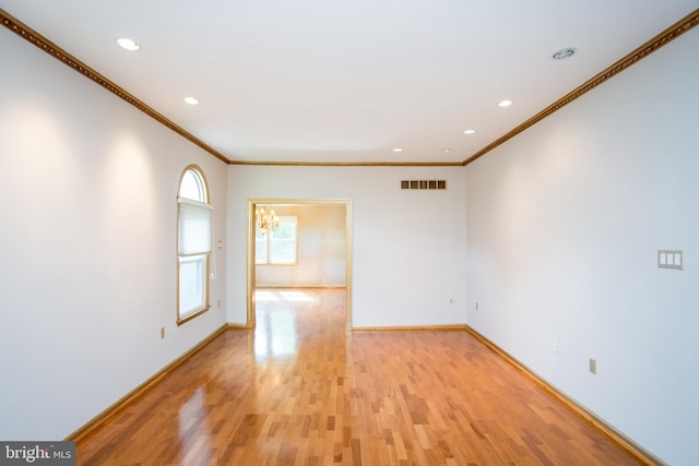 unfurnished room featuring recessed lighting, baseboards, ornamental molding, and light wood-type flooring