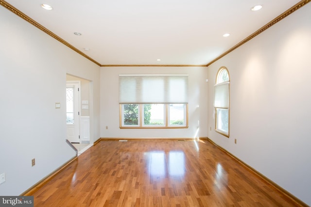 empty room with crown molding, recessed lighting, and light wood-type flooring
