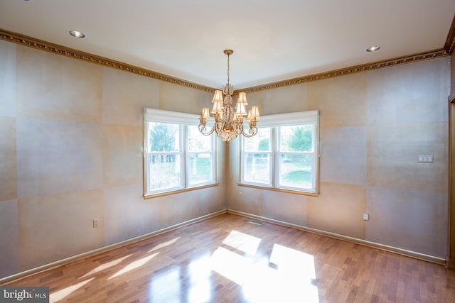 unfurnished room featuring recessed lighting, a chandelier, ornamental molding, and wood finished floors