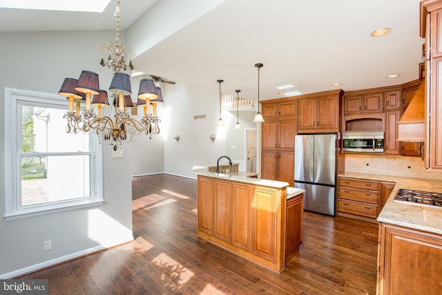kitchen with an island with sink, dark wood-type flooring, recessed lighting, a chandelier, and stainless steel appliances