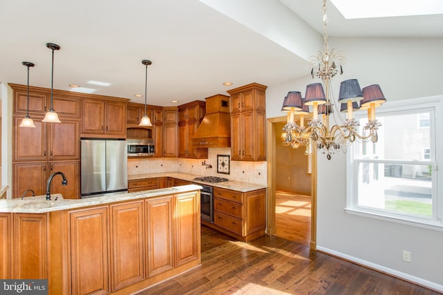 kitchen featuring a notable chandelier, brown cabinetry, premium range hood, stainless steel appliances, and dark wood-style floors