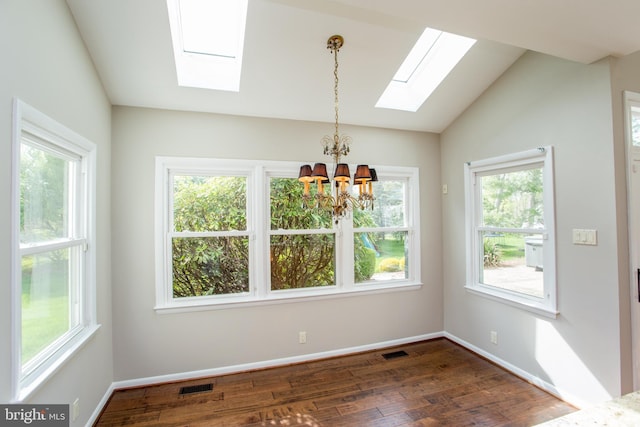 unfurnished dining area featuring a chandelier, visible vents, a healthy amount of sunlight, and vaulted ceiling with skylight