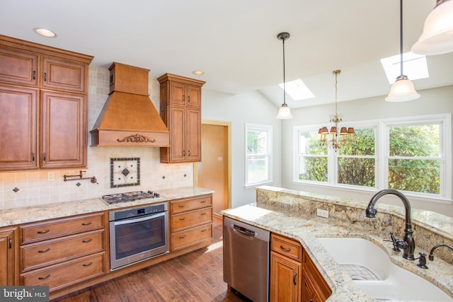 kitchen with decorative backsplash, dark wood-style flooring, custom range hood, a sink, and stainless steel appliances