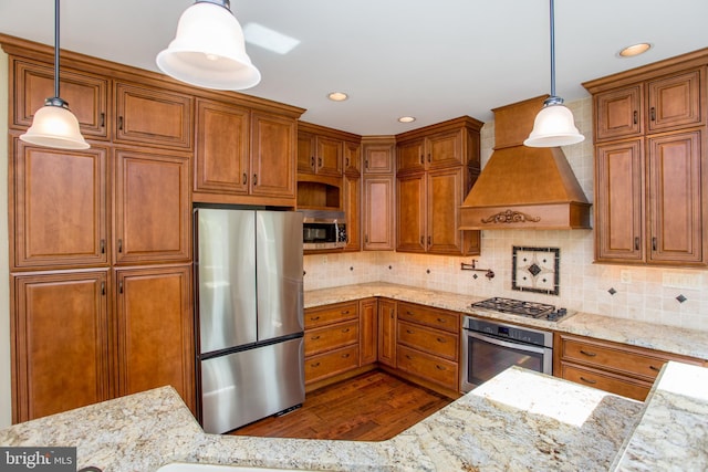 kitchen with stainless steel appliances, light stone counters, brown cabinetry, and dark wood-type flooring
