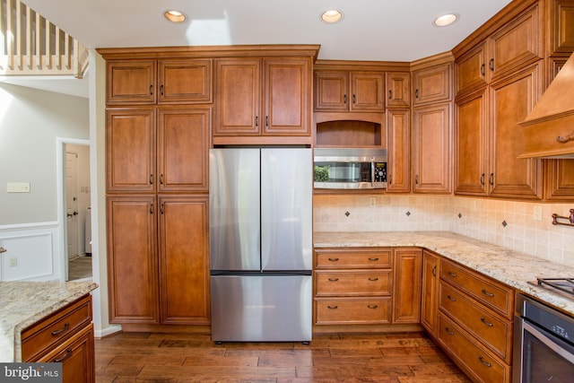 kitchen with brown cabinetry, recessed lighting, dark wood-style floors, and stainless steel appliances