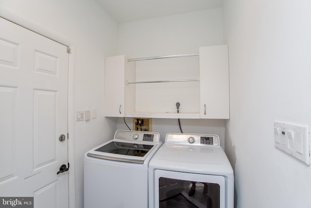 laundry room with cabinet space and washing machine and dryer