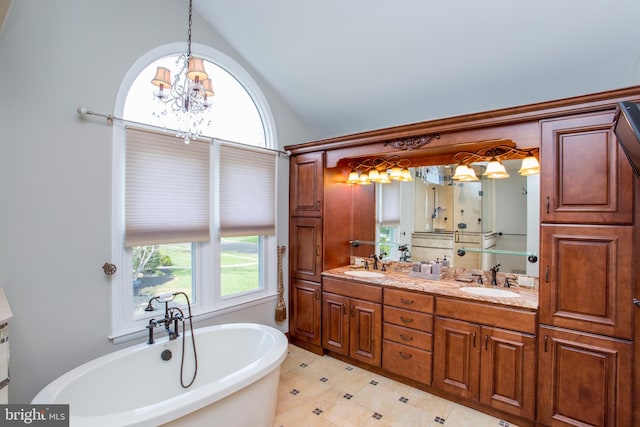 full bath with double vanity, a sink, and a freestanding tub