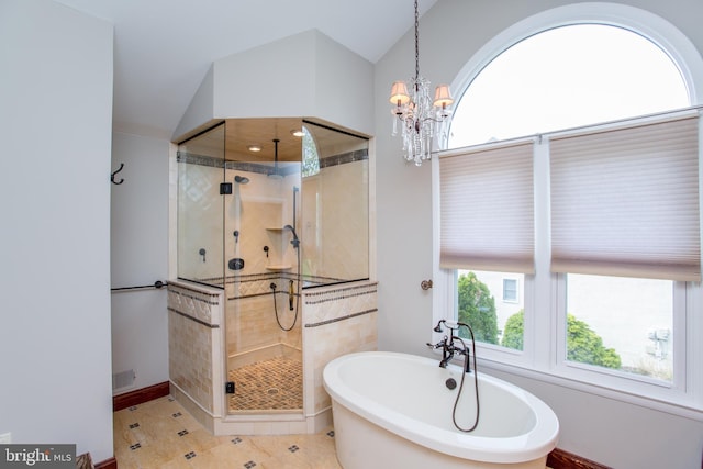 bathroom featuring a freestanding bath, a stall shower, baseboards, lofted ceiling, and an inviting chandelier