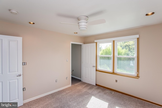 unfurnished bedroom featuring carpet, recessed lighting, baseboards, a ceiling fan, and visible vents