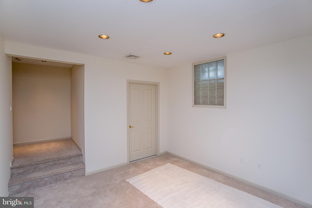 unfurnished room featuring baseboards, visible vents, recessed lighting, and light colored carpet