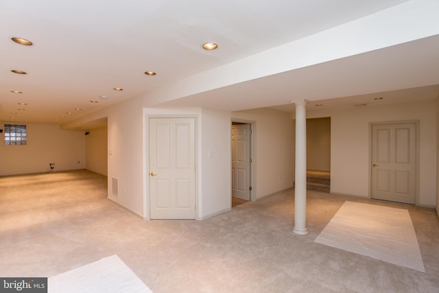 finished below grade area featuring light colored carpet and recessed lighting