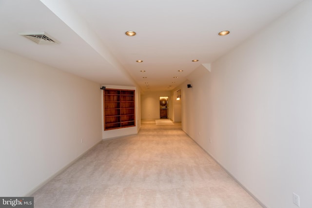 corridor with visible vents, recessed lighting, baseboards, and light carpet