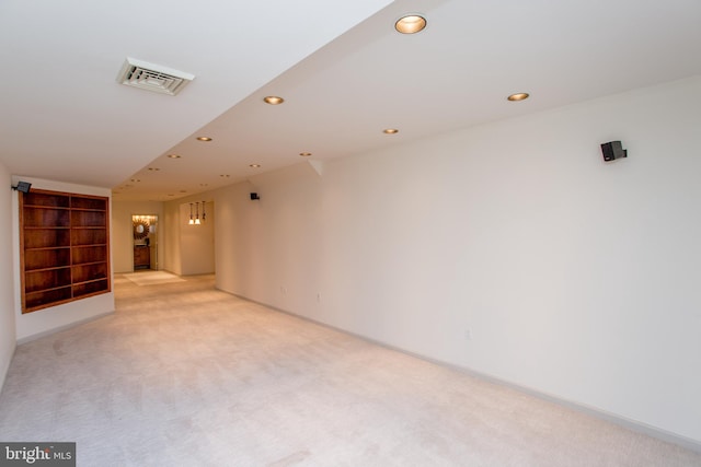 basement featuring visible vents, recessed lighting, baseboards, and light carpet