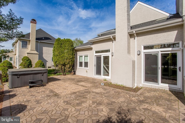 view of patio / terrace with a hot tub