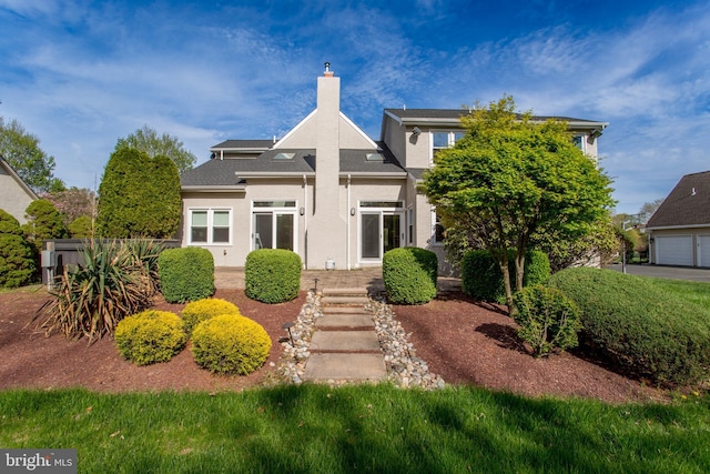 view of front of property featuring a chimney and stucco siding