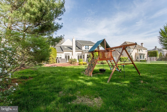 view of jungle gym featuring a lawn