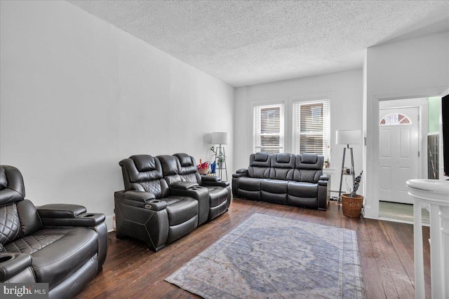 living area with hardwood / wood-style flooring and a textured ceiling