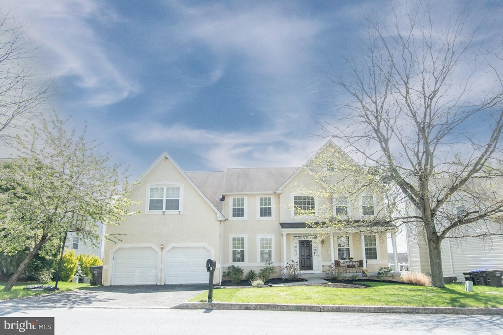 6 Hunters Hill Dr, Morgantown, PA 19543 - view of front of house featuring a garage, stucco siding, driveway, and a front yard