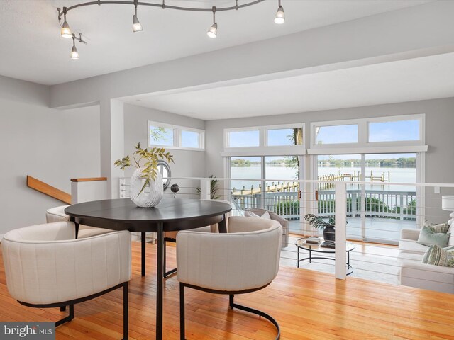 504 Moorings Cir, Arnold, MD 21012 - dining area with rail lighting, hardwood / wood-style floors, and a water view