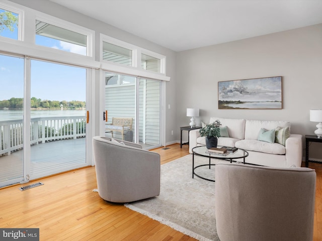 504 Moorings Cir, Arnold, MD 21012 - living area featuring wood finished floors, visible vents, and a water view