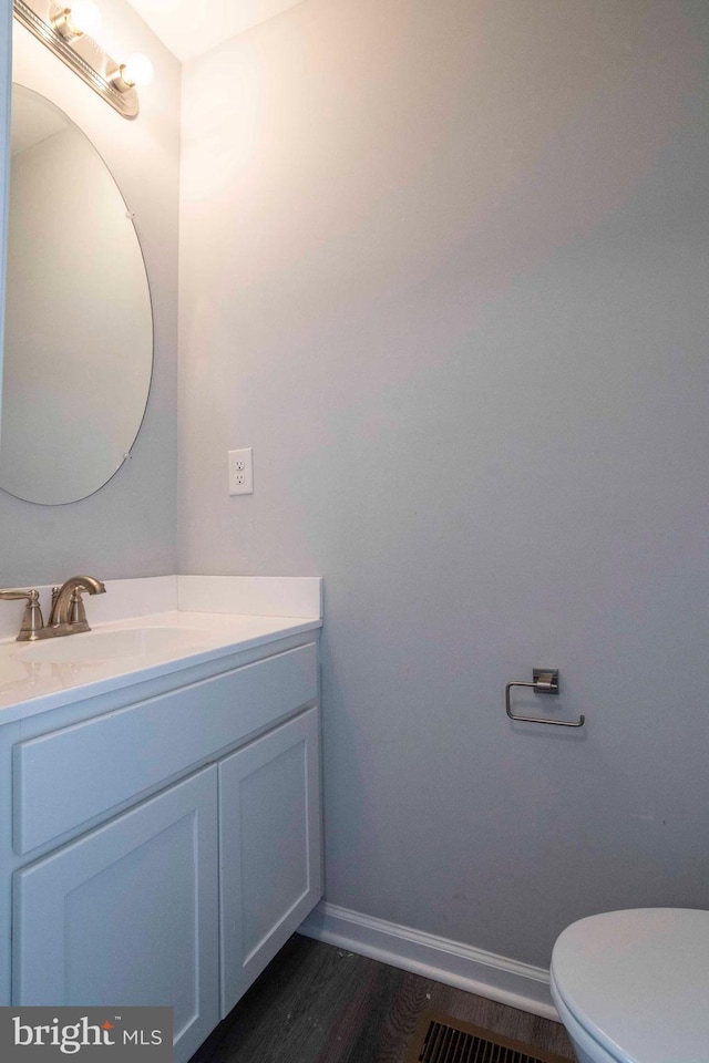 112 Ryder Benson Ln, Front Royal, VA 22630 - bathroom with baseboards, toilet, vanity, and wood finished floors