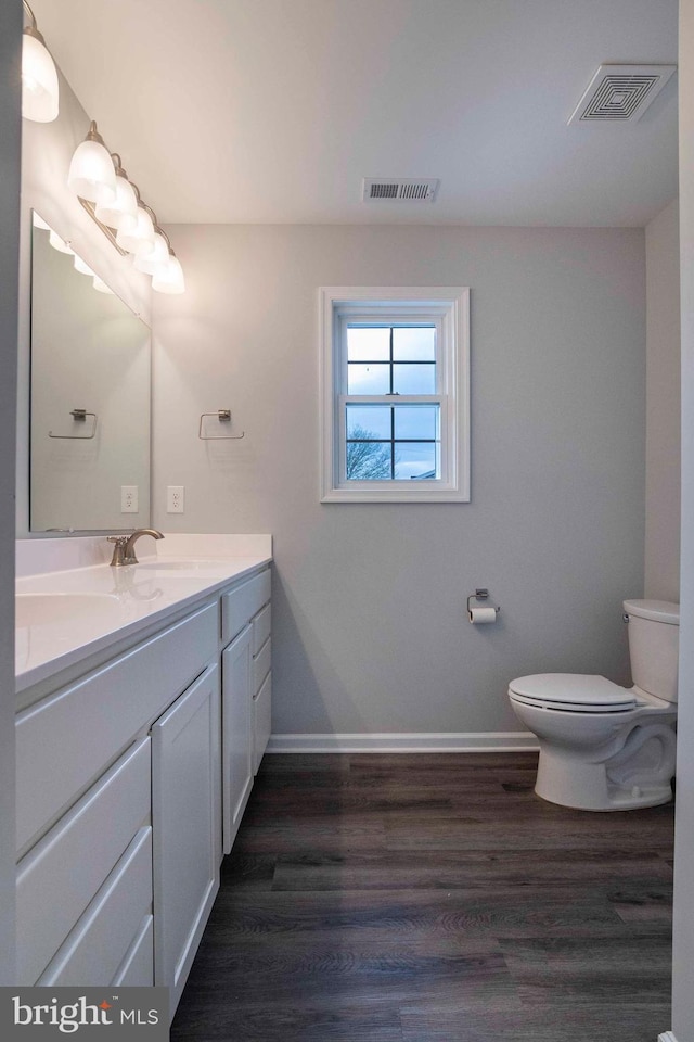 112 Ryder Benson Ln, Front Royal, VA 22630 - bathroom featuring toilet, vanity, wood finished floors, and visible vents