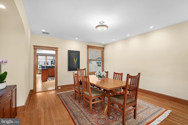 dining room with light wood-style floors, baseboards, recessed lighting, and visible vents