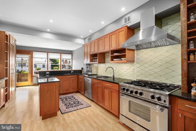kitchen with wall chimney exhaust hood, open shelves, a sink, and appliances with stainless steel finishes
