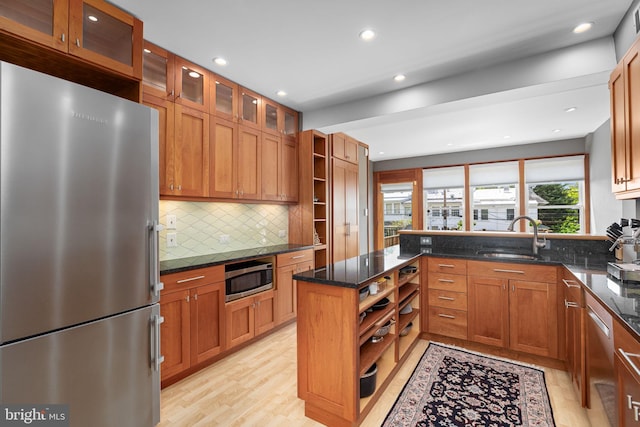 kitchen with open shelves, decorative backsplash, light wood-type flooring, a sink, and stainless steel appliances