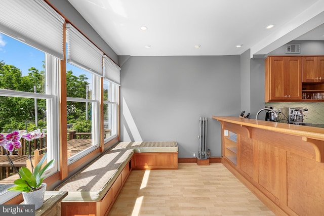 interior space featuring recessed lighting, decorative backsplash, light wood-type flooring, and visible vents