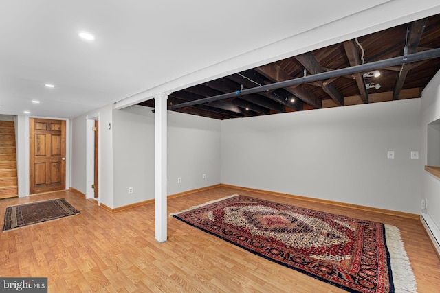 finished basement featuring recessed lighting, baseboards, and wood finished floors