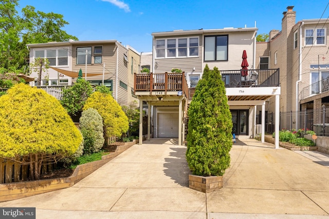 view of front of property with a garage, a carport, stucco siding, and concrete driveway