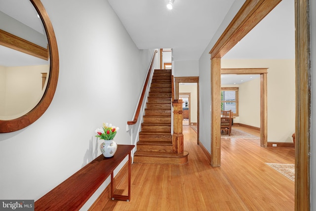 staircase with baseboards and wood finished floors