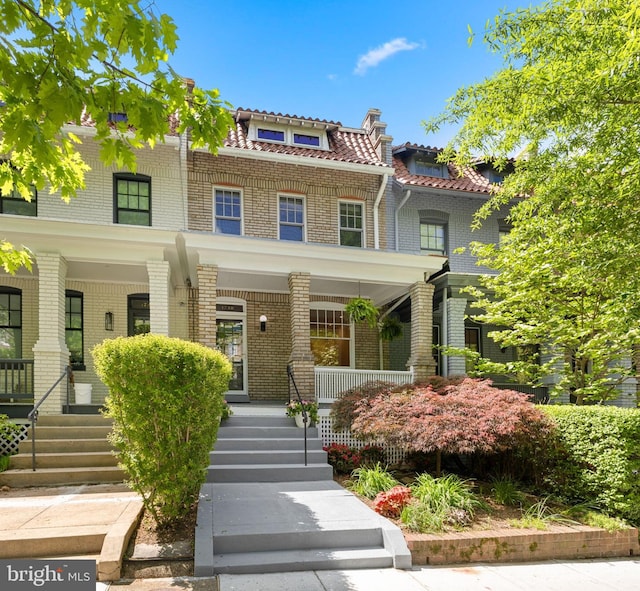 view of front of property featuring a porch and brick siding