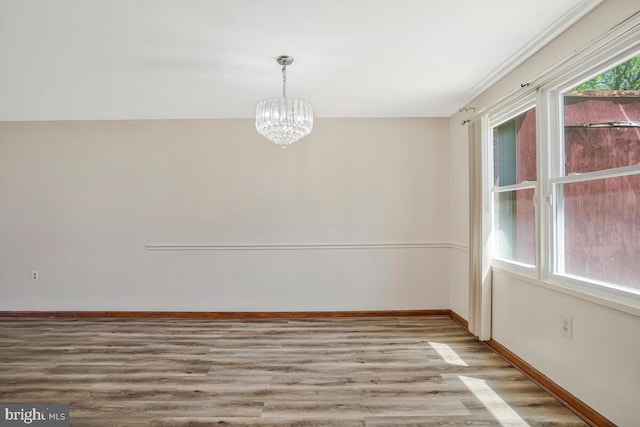 1603 Melby Ct, Baltimore, MD 21234 - unfurnished dining area with baseboards, wood finished floors, and a chandelier