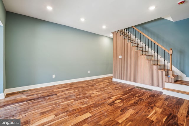 interior space featuring recessed lighting, visible vents, stairway, and wood finished floors