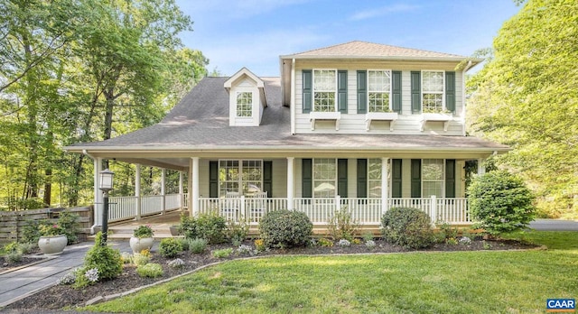 farmhouse inspired home with covered porch and a front lawn