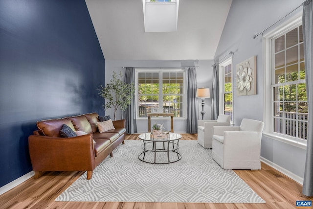 living room featuring high vaulted ceiling, a wealth of natural light, and wood finished floors