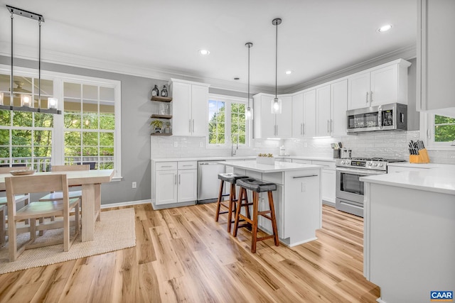 kitchen with light wood-style floors, white cabinetry, and appliances with stainless steel finishes